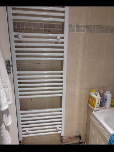 Heated towel rail installed in a bathroom