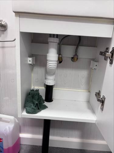 Pipework fitted under a bathroom vanity unit