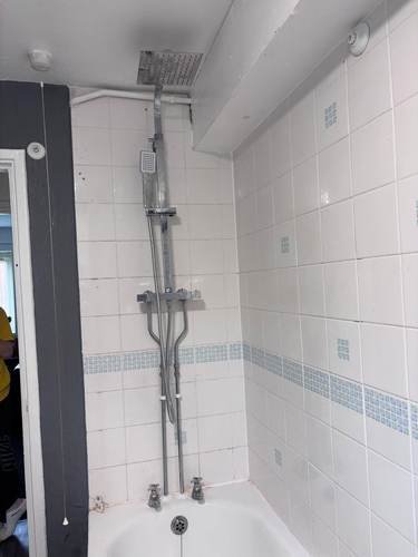 Bath installation with shower mixer and tiled surround