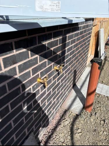 Heating pipework fitted to an exterior wall