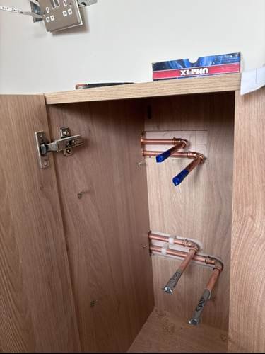 First-fix pipework fitted inside a cabinet