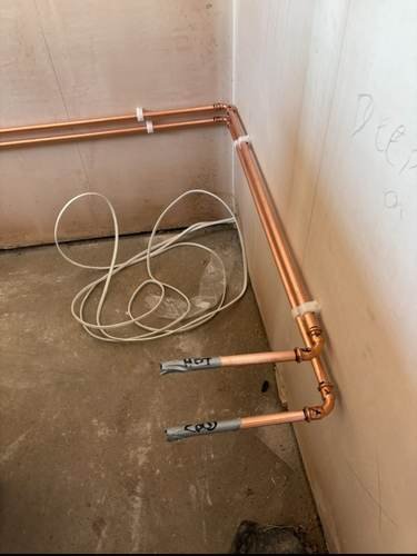 First-fix copper pipework fitted along a wall