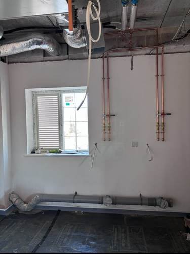 First-fix copper pipework fitted to a ceiling