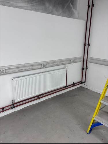 Radiator installed with first-fix pipework