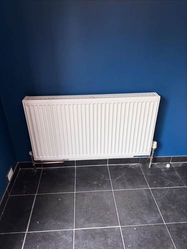 Radiator installed on a tiled floor