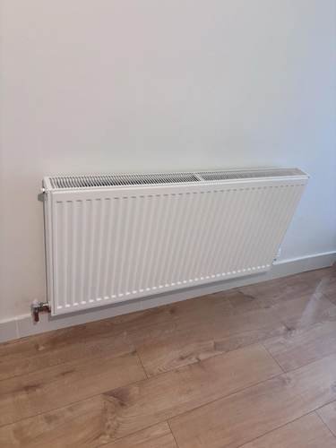 Radiator installed on a wood floor