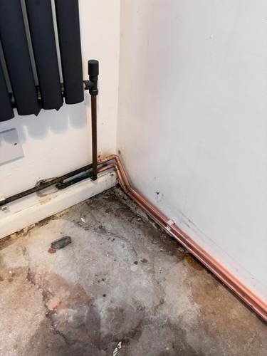 First-fix heating pipework fitted along a stripped-out floor