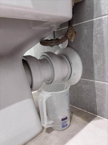 Kitchen extractor duct and pipework fitted under sink