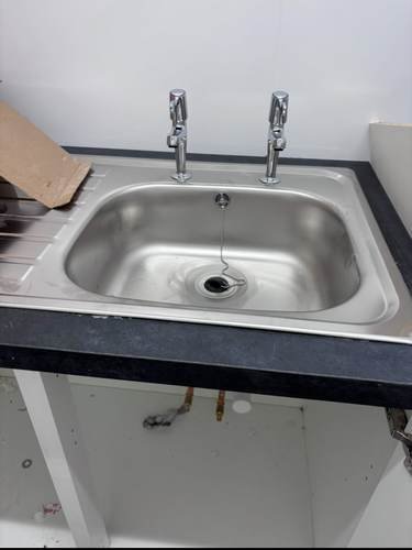 Stainless steel kitchen sink ready for tap installation