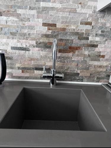 Kitchen sink and mixer tap installation with stone worktop