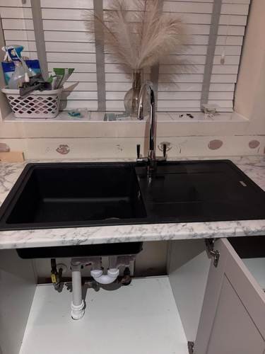 Kitchen sink installation below a window