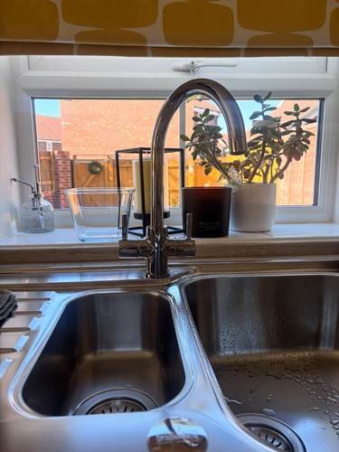 Kitchen sink and mixer tap with a window view